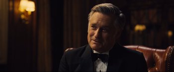 Movie still from “Battle of the Sexes” (2017), directed by Valerie Faris – An older man in a suit and bow tie looking to his left; Close Up shot, Over the shoulder angle