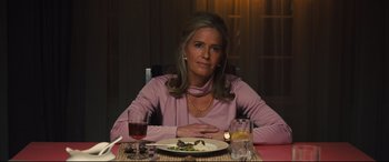 Movie still from “Battle of the Sexes” (2017), directed by Valerie Faris – A woman sitting at a table with a plate of food on it; Medium shot, Over the shoulder angle