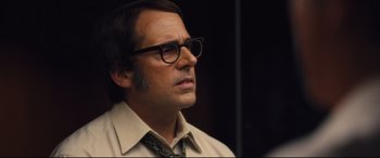 Movie still from “Battle of the Sexes” (2017), directed by Valerie Faris – A person wearing glasses and a tie; Close Up shot, Over the shoulder angle