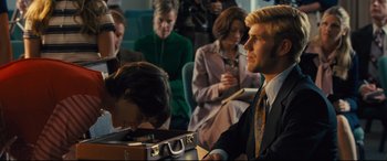 Movie still from “Battle of the Sexes” (2017), directed by Valerie Faris – A group of people sitting in a room; Medium shot, Over the shoulder angle