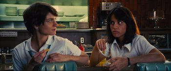 Movie still from “Battle of the Sexes” (2017), directed by Valerie Faris – A man and a woman sitting at a table in a restaurant; Medium shot, Over the shoulder angle
