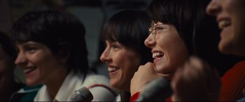 Movie still from “Battle of the Sexes” (2017), directed by Valerie Faris – A couple of people that are sitting in front of microphones; Close Up shot, Over the shoulder angle