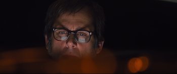 Movie still from “Battle of the Sexes” (2017), directed by Valerie Faris – A person wearing glasses with a blurry background; Close Up shot, Low angle