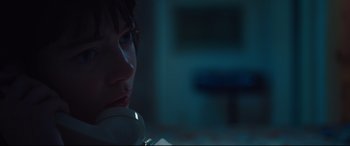 Movie still from “Battle of the Sexes” (2017), directed by Valerie Faris – A woman is talking on the phone in the dark; Close Up shot, Low angle