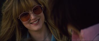 Movie still from “Battle of the Sexes” (2017), directed by Valerie Faris – A person wearing sunglasses; Close Up shot, Over the shoulder angle