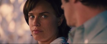 Movie still from “Battle of the Sexes” (2017), directed by Valerie Faris – A woman's face with a man in the background; Close Up shot, Over the shoulder angle