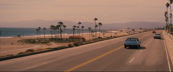 Movie still from “Battle of the Sexes” (2017), directed by Valerie Faris – A view of the beach from the side of the road; Extreme Wide shot, High angle