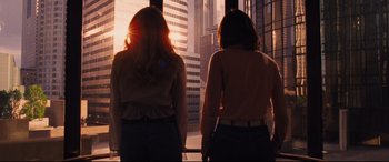Movie still from “Battle of the Sexes” (2017), directed by Valerie Faris – Two women looking out of a window at a city skyline; Medium shot, Low angle