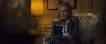 Movie still from “Battle of the Sexes” (2017), directed by Valerie Faris – A woman sitting in a chair in front of a lamp; Medium shot, Over the shoulder angle