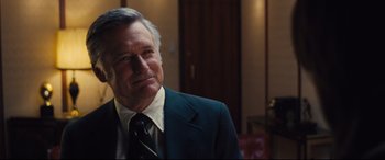 Movie still from “Battle of the Sexes” (2017), directed by Valerie Faris – An older man wearing a suit and tie; Close Up shot, Over the shoulder angle