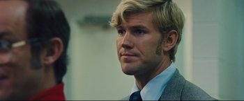 Movie still from “Battle of the Sexes” (2017), directed by Valerie Faris – A person wearing a suit and tie; Close Up shot, Over the shoulder angle