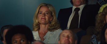 Movie still from “Battle of the Sexes” (2017), directed by Valerie Faris – A woman sitting next to a man in a suit; Close Up shot, Low angle