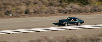 Movie still from “Battle Los Angeles” (2011), directed by Jonathan Liebesman – A car driving down a road near some bushes; Wide shot, High angle