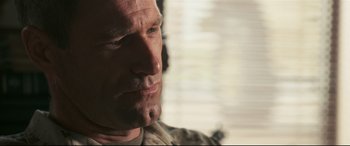 Movie still from “Battle Los Angeles” (2011), directed by Jonathan Liebesman – A man's face in front of a window; Close Up shot, Over the shoulder angle