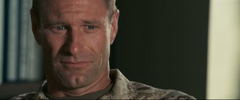 Movie still from “Battle Los Angeles” (2011), directed by Jonathan Liebesman – A person wearing a military uniform; Close Up shot, Over the shoulder angle