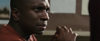 Movie still from “Battle Los Angeles” (2011), directed by Jonathan Liebesman – A person with his hands clasped together; Close Up shot, Over the shoulder angle