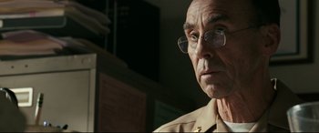Movie still from “Battle Los Angeles” (2011), directed by Jonathan Liebesman – An older man wearing glasses looking at the camera; Close Up shot, Over the shoulder angle