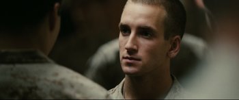 Movie still from “Battle Los Angeles” (2011), directed by Jonathan Liebesman – A person wearing a military uniform; Close Up shot, Over the shoulder angle