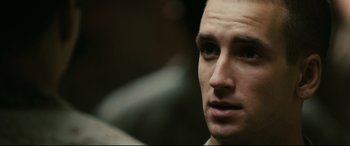 Movie still from “Battle Los Angeles” (2011), directed by Jonathan Liebesman – A man's face in a dimly - lit room; Close Up shot, Over the shoulder angle