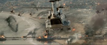 Movie still from “Battle Los Angeles” (2011), directed by Jonathan Liebesman – A military helicopter flying over a burning field; Extreme Wide shot, High angle