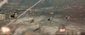 Movie still from “Battle Los Angeles” (2011), directed by Jonathan Liebesman – An aerial view of a helicopter flying over a city; Extreme Wide shot, High angle