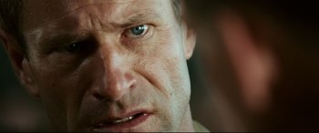 Movie still from “Battle Los Angeles” (2011), directed by Jonathan Liebesman – A man's face with blue eyes; Extreme Close Up shot, Over the shoulder angle