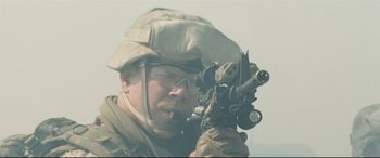 Movie still from “Battle Los Angeles” (2011), directed by Jonathan Liebesman – A man in a helmet and goggles holding a rifle; Close Up shot, Low angle