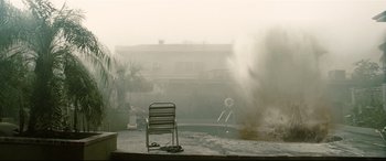 Movie still from “Battle Los Angeles” (2011), directed by Jonathan Liebesman – A chair sitting in front of a swimming pool; Extreme Wide shot, Low angle