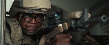 Movie still from “Battle Los Angeles” (2011), directed by Jonathan Liebesman – A soldier is holding a rifle and aiming it; Close Up shot, Over the shoulder angle