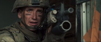 Movie still from “Battle Los Angeles” (2011), directed by Jonathan Liebesman – A person holding a gun; Close Up shot, Over the shoulder angle