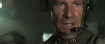 Movie still from “Battle Los Angeles” (2011), directed by Jonathan Liebesman – A person wearing a helmet; Close Up shot, Low angle