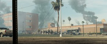 Movie still from “Battle Los Angeles” (2011), directed by Jonathan Liebesman – A group of people are walking through a street; Extreme Wide shot, High angle