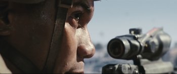 Movie still from “Battle Los Angeles” (2011), directed by Jonathan Liebesman – A person with a rifle; Extreme Close Up shot, Low angle