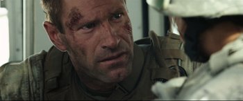 Movie still from “Battle Los Angeles” (2011), directed by Jonathan Liebesman – A person wearing a helmet; Close Up shot, Over the shoulder angle