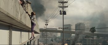 Movie still from “Battle Los Angeles” (2011), directed by Jonathan Liebesman – Two people standing on the side of a building looking out over a city; Wide shot, Low angle