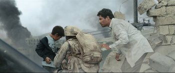 Movie still from “Battle Los Angeles” (2011), directed by Jonathan Liebesman – A group of men standing next to each other on top of a hill; Medium shot, Low angle