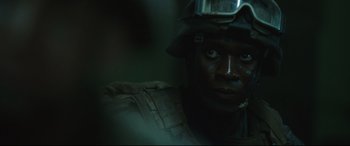 Movie still from “Battle Los Angeles” (2011), directed by Jonathan Liebesman – A person wearing a helmet; Close Up shot, Over the shoulder angle