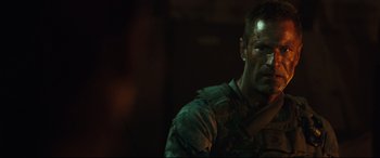 Movie still from “Battle Los Angeles” (2011), directed by Jonathan Liebesman – A man in a military uniform is holding a rifle; Close Up shot, Over the shoulder angle