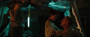 Movie still from “Battle Los Angeles” (2011), directed by Jonathan Liebesman – A man and a boy are standing under a tent; Medium shot, Over the shoulder angle