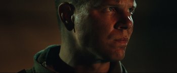 Movie still from “Battle Los Angeles” (2011), directed by Jonathan Liebesman – A person's face with ear plugs on; Close Up shot, Over the shoulder angle
