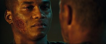 Movie still from “Battle Los Angeles” (2011), directed by Jonathan Liebesman – A man's face in front of another man; Close Up shot, Over the shoulder angle