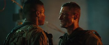 Movie still from “Battle Los Angeles” (2011), directed by Jonathan Liebesman – Two men are facing each other in a dark room; Close Up shot, Low angle