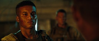 Movie still from “Battle Los Angeles” (2011), directed by Jonathan Liebesman – A man in a military uniform standing next to another man; Close Up shot, Over the shoulder angle