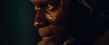 Movie still from “Battle Los Angeles” (2011), directed by Jonathan Liebesman – A man's face with dark lighting; Extreme Close Up shot, Low angle