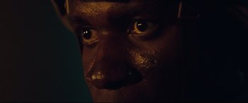 Movie still from “Battle Los Angeles” (2011), directed by Jonathan Liebesman – A person's face with a dark background; Extreme Close Up shot, Low angle