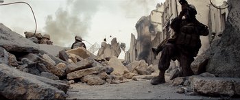 Movie still from “Battle Los Angeles” (2011), directed by Jonathan Liebesman – Two men are standing in the middle of a destroyed city; Wide shot, Low angle