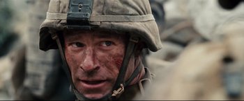 Movie still from “Battle Los Angeles” (2011), directed by Jonathan Liebesman – A person wearing a helmet; Close Up shot, Over the shoulder angle