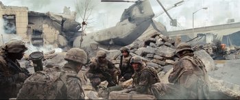Movie still from “Battle Los Angeles” (2011), directed by Jonathan Liebesman – A group of soldiers sitting on a pile of rocks; Extreme Wide shot, High angle