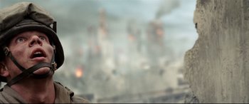 Movie still from “Battle Los Angeles” (2011), directed by Jonathan Liebesman – A blurry picture of a city with smoke coming out of it's windows; Close Up shot, Low angle