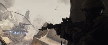 Movie still from “Battle Los Angeles” (2011), directed by Jonathan Liebesman – A soldier is holding a rifle in the air; Wide shot, Low angle